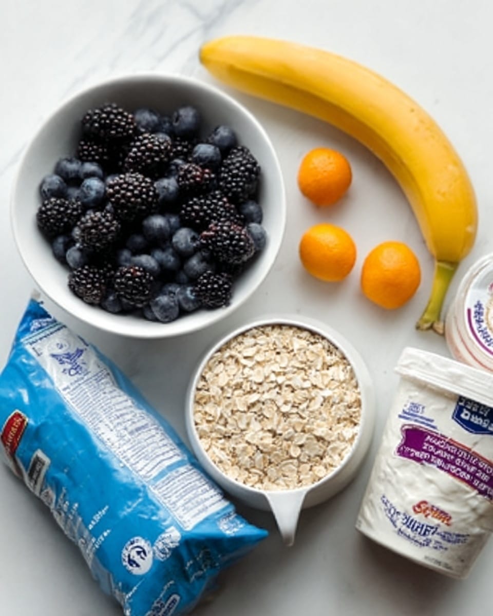 The image shows a white bowl filled with a mix of blueberries and blackberries placed on a white marbled surface. Next to it is a white measuring cup filled with beige oats, positioned near a yellow banana lying flat on the surface. Two small orange fruits, possibly kumquats, rest near the bowl, while two containers of dairy products, one labeled yogurt and the other cottage cheese, are placed nearby. A blue bag of oats is positioned behind the dairy containers. The colors include the dark blue and black of the berries, the yellow of the banana, the orange of the small fruits, and the mostly white packaging of the dairy and oat products. photo taken with an iphone --ar 4:5 --v 7