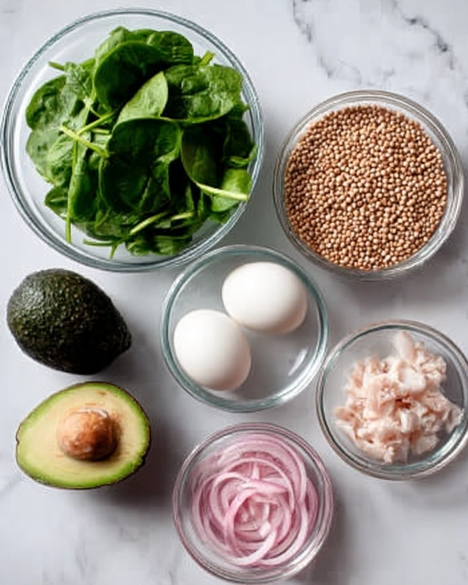 The image shows six clear glass bowls on a white marbled surface. One bowl contains fresh green spinach leaves, smooth and leafy, positioned on the left. Next to it is a bowl with two white eggs, smooth and oval, placed in the center. Above the eggs is a bowl filled with small, round, beige grains, likely uncooked cereal or seeds. To the right of the grains is another bowl with small pieces of white and pink chopped meat or seafood. Below that is a bowl with thinly sliced, bright pink and white onions. In the top left corner, an avocado with dark green, textured skin sits next to the bowls. The light is soft, showing clear details and shadows. Photo taken with an iphone --ar 4:5 --v 7
