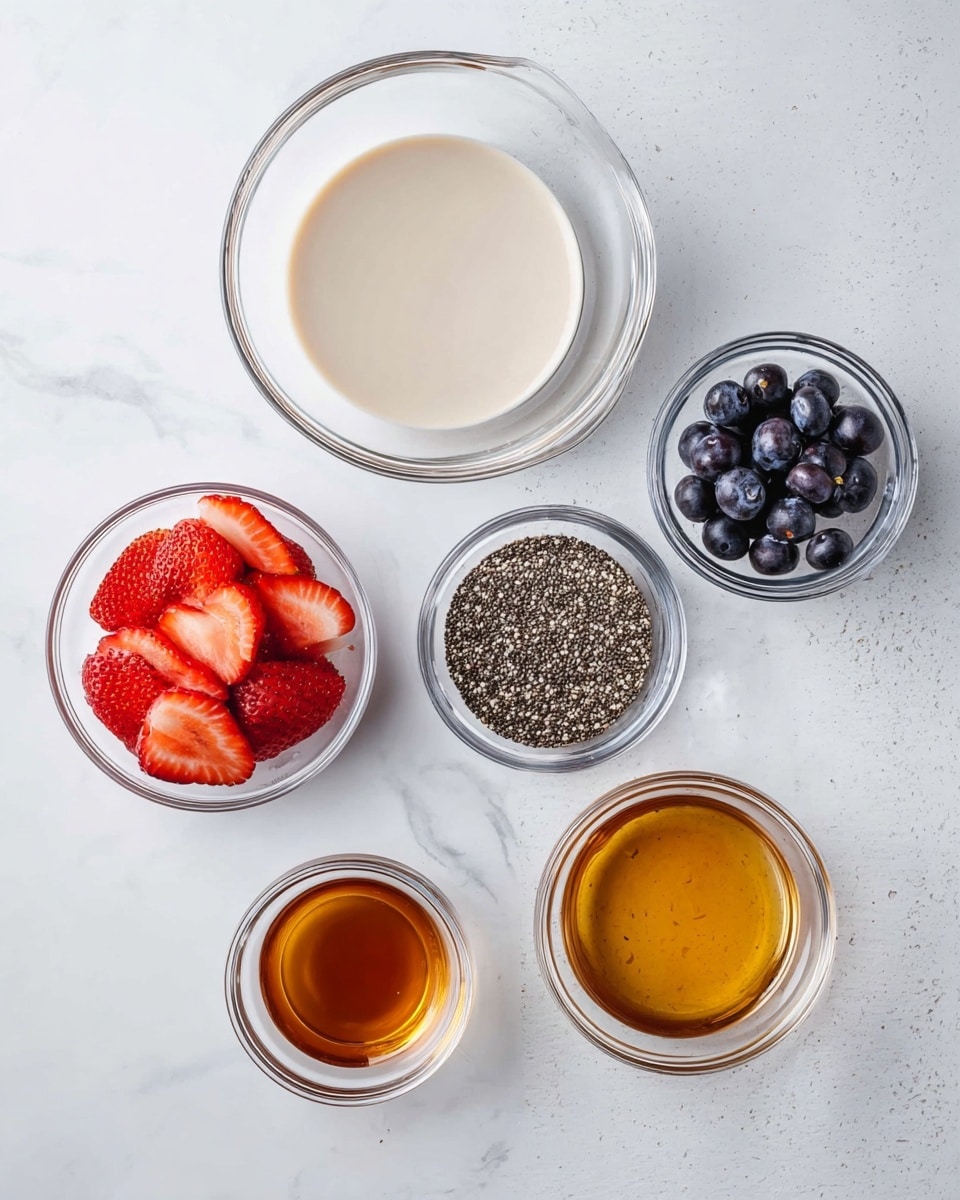 The image shows six clear glass bowls placed on a white marbled surface, each holding different ingredients. The largest bowl is filled with a pale, creamy liquid that looks smooth. To its right, there are two small bowls, one with dark, glossy blueberries and another with a small amount of light brown liquid. Below them, there is a bowl full of small, black and white speckled chia seeds with a rough texture. To the left, a small bowl holds bright red, sliced strawberries with a juicy texture. Finally, below the strawberries, there is another small bowl with a deep golden brown liquid that looks smooth and shiny. Photo taken with an iphone --ar 4:5 --v 7