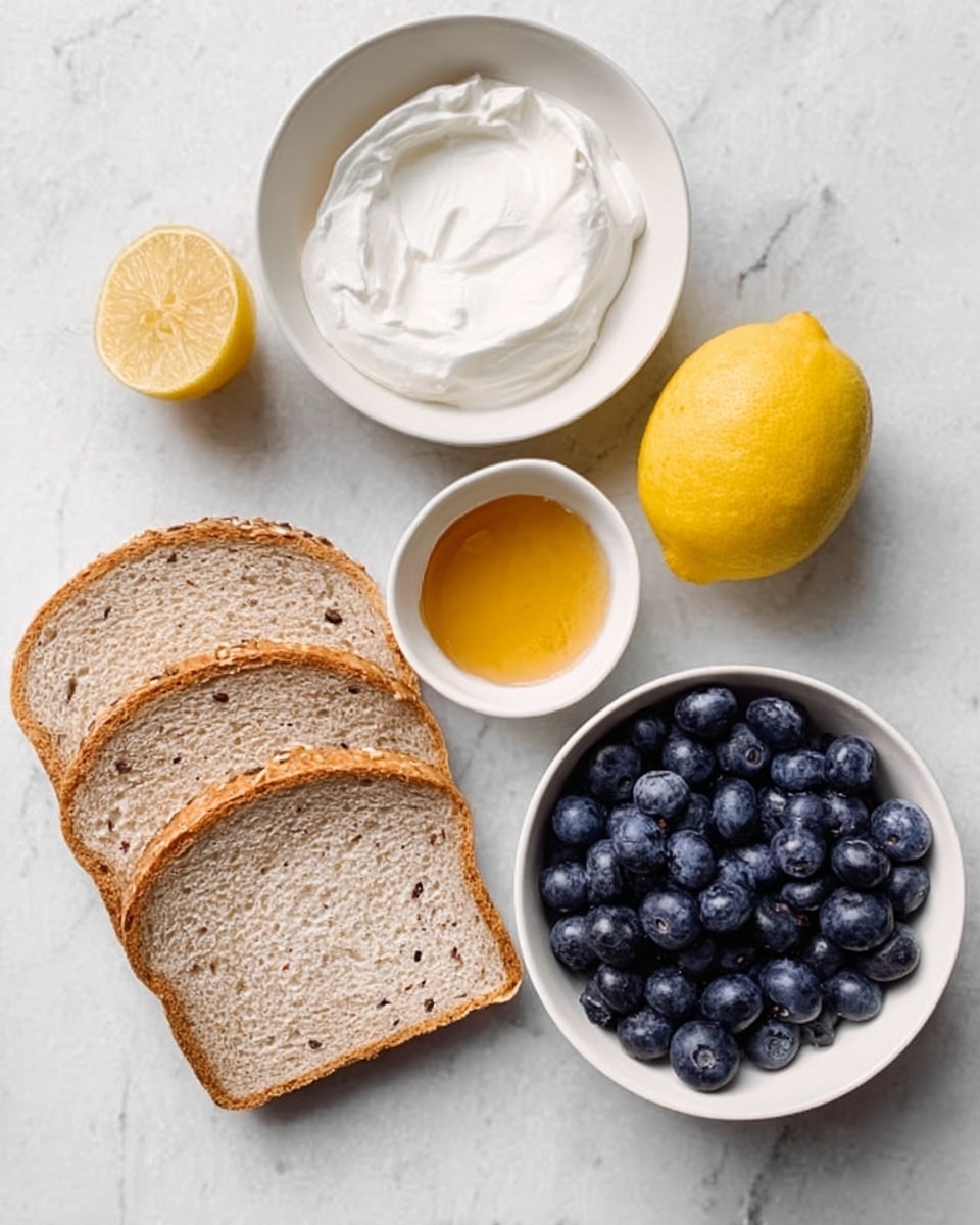 The image shows a white marbled surface with four slices of light brown bread with visible seeds on the lower left. Above the bread, there is a small white bowl filled with thick white cream. To the right of the cream, a whole yellow lemon sits on the surface. Below the lemon, a small white cup contains golden honey. On the right side, a white bowl is full of fresh, dark blue blueberries, showing a smooth and plump texture. photo taken with an iphone --ar 4:5 --v 7
