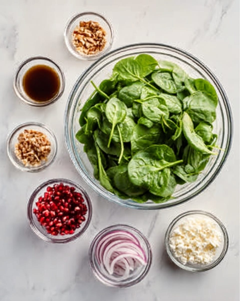 A large clear glass bowl filled with bright green spinach leaves sits on a white marbled surface. Surrounding the bowl are six small clear glass bowls arranged in a loose circle. Each small bowl holds a different ingredient: one has a dark brown liquid, another is filled with small brown nut pieces, a third contains white granules that look like cheese, the fourth has thin slices of light purple onion, the fifth is full of red pomegranate seeds, and the last one holds crumbled white cheese. The scene is clean and bright, with soft natural light highlighting the fresh colors of each ingredient. photo taken with an iphone --ar 4:5 --v 7