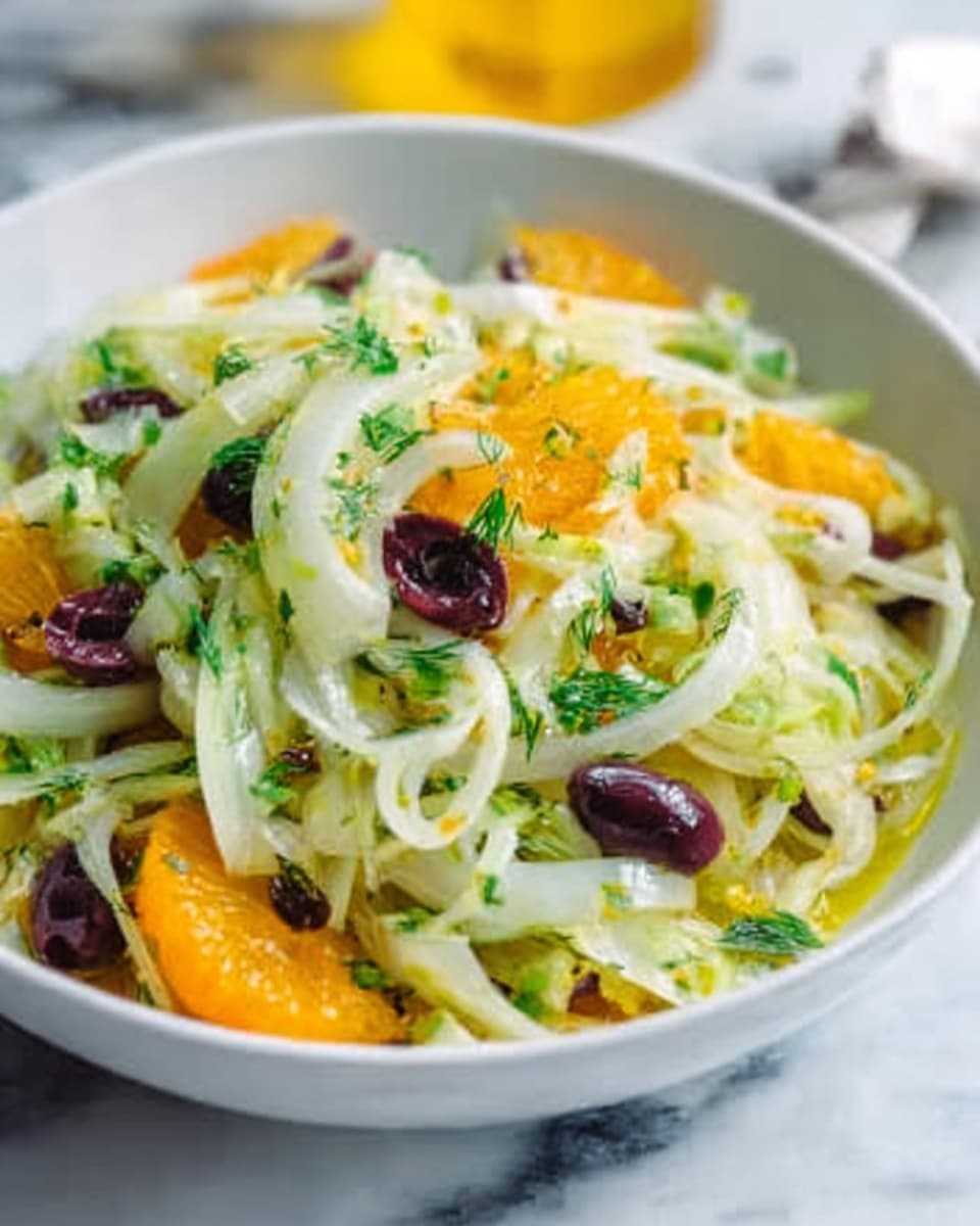 A white bowl filled with a salad made of thin curls of pale green and white fennel layered with bright orange segments and scattered dark purple olive slices. The salad is sprinkled with small bits of fresh green herbs and lightly dressed with a sheen of oil, giving the ingredients a fresh and glossy look. The bowl sits on a white marbled surface, and a blurred yellow object is visible in the background. photo taken with an iphone --ar 4:5 --v 7