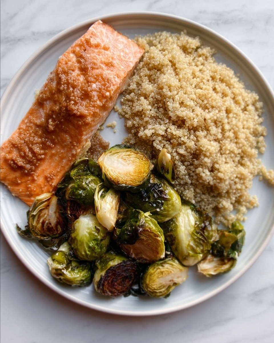 The dish shows a white plate with three main parts: a large piece of cooked salmon with a crispy light brown top layer on the upper left, a heap of fluffy, light beige quinoa on the right, and a pile of roasted Brussels sprouts with charred dark green and brown edges at the bottom left. The salmon's texture looks soft with a slightly crispy outer layer, and the quinoa is grainy and evenly piled. The Brussels sprouts have a mix of crispy and tender leaves, giving a contrast of dark and bright green colors. The plate is set on a white marbled surface. Photo taken with an iphone --ar 4:5 --v 7