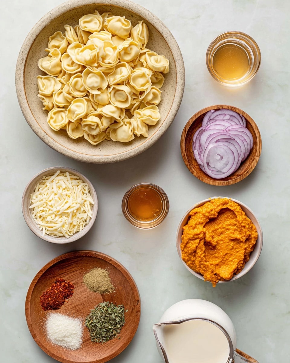 A top-down view of several ingredients on a white marbled surface, including a large round bowl filled with uncooked tortellini pasta that is pale yellow with a smooth texture, a small white bowl of shredded cheese that is light yellow, a small wooden bowl with a vibrant orange thick paste, a small wooden bowl of white grated cheese, a wooden plate with finely sliced red onions and chopped green herbs, another wooden plate with six small piles of spices including red chili flakes, minced garlic, and various powders, a glass container of clear liquid, a small glass of light brown liquid, and a white ceramic pitcher filled with a creamy white liquid, photo taken with an iphone --ar 4:5 --v 7