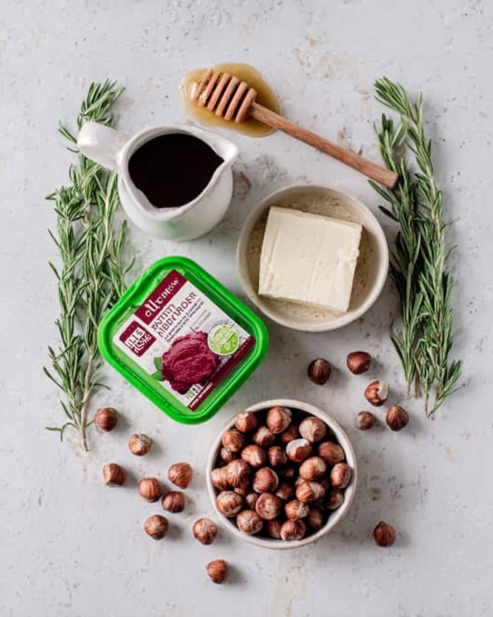 The image shows a top view of a white marbled surface with several food items arranged on it. In the center, there is a green plastic container of red beetroot paste, with the label visible. To the right, a round white bowl holds a block of white cheese. Below the container is a white bowl filled with whole hazelnuts, some scattered outside the bowl on the surface. Fresh green rosemary sprigs are placed around the items, creating a natural look. At the top, there is a white jug filled with a dark liquid, next to a wooden honey dipper that rests on the surface. The colors are natural and earthy, with green, white, brown, and red standing out. photo taken with an iphone --ar 4:5 --v 7