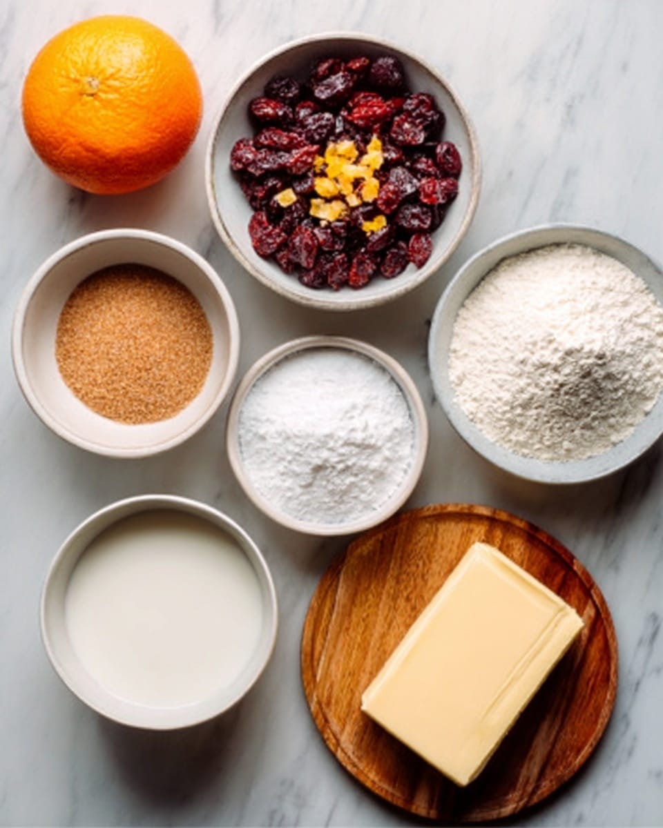 The image shows a top view of baking ingredients on a white marbled surface. There is a white bowl filled with dried cranberries mixed with small yellow pieces, placed near the top center. To the left is an orange fruit. Below the orange, a small white bowl contains brown sugar. To the right, there is a white bowl full of white flour. Below the flour bowl, a white bowl holds white granulated sugar. To the lower left, another white bowl contains a white liquid, likely milk. On the lower right, a wooden plate holds a rectangular block of butter. The colors and textures contrast well against the smooth white marbled background. Photo taken with an iphone --ar 4:5 --v 7