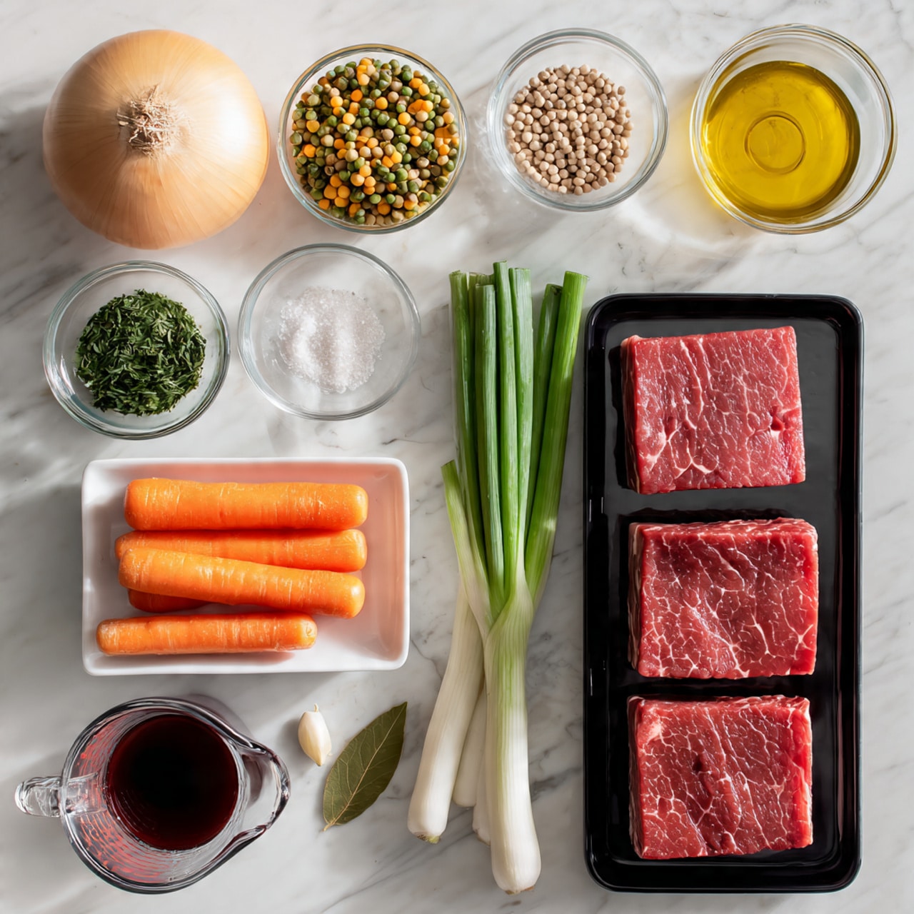 A white marbled surface holds several clear glass and white dishes arranged neatly: at the top left, a whole pale yellow onion; below it, a small clear bowl filled with mixed dried split peas and lentils in green, white, and yellow colors; to its right, a black tray with six thick pieces of red marbled raw meat stacked in two rows; next to the meat, on a white rectangular plate, three bright orange carrots, one white root, and several green onion stalks lying side by side with two peeled garlic cloves at the bottom; below the carrots, a clear measuring cup filled with dark liquid; to the left of that, a glass jar of deep red sauce; nearby, a small glass bowl of light green chopped herbs, a small glass bowl of golden yellow oil, another small glass bowl containing white salt with black pepper on top, and a single bay leaf resting directly on the marble. The photo taken with an iphone --ar 4:5 --v 7