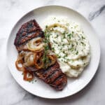 Steak with Caramelized Onions and Herb Mashed Potatoes Recipe