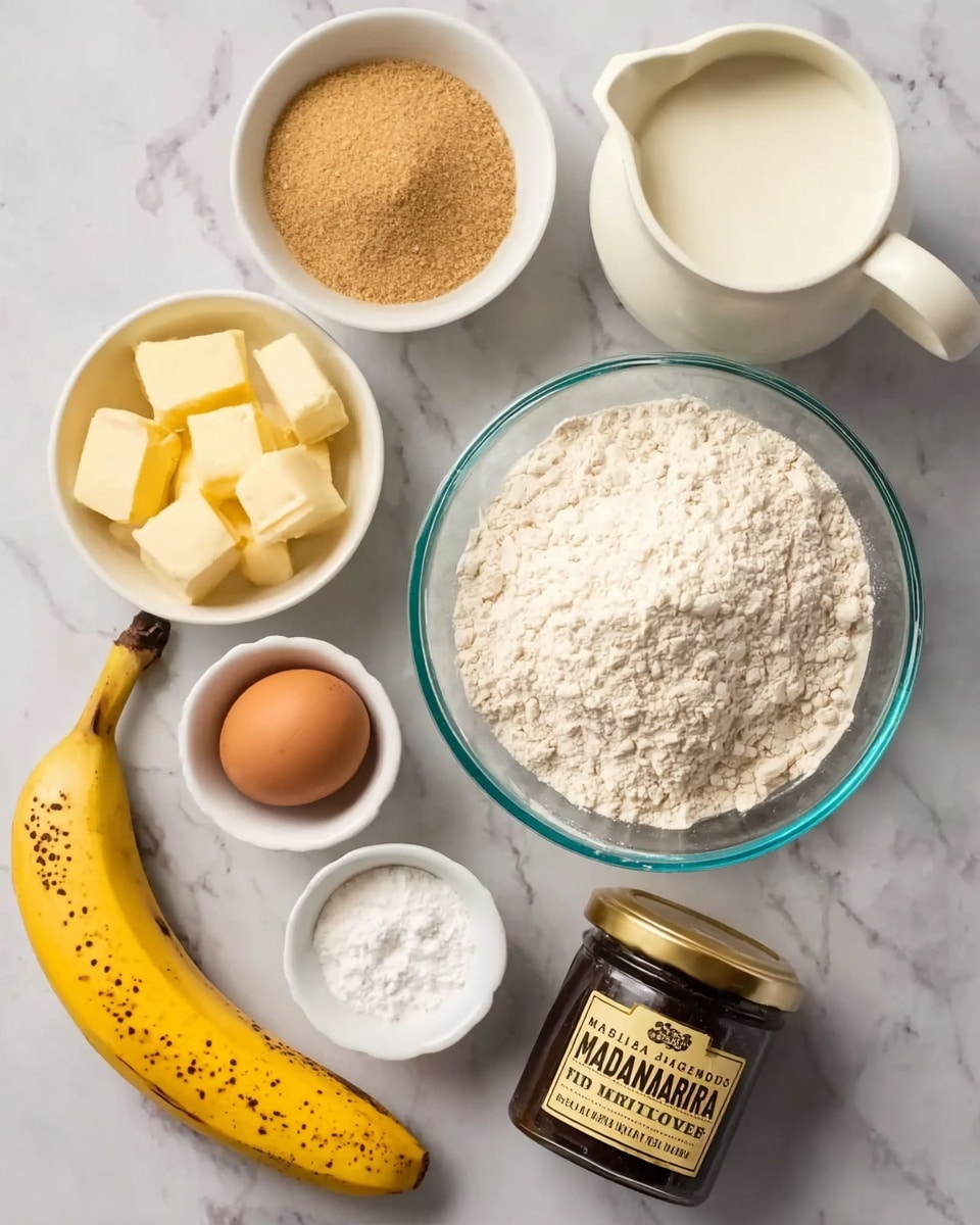 The image shows eight separate ingredients laid out on a white marbled surface. In the top right is a white jug filled with milk, and just below it, a clear glass bowl holds a large mound of white flour. To the left of the flour bowl is a small white bowl filled with light brown sugar, and directly above this is another small white bowl containing pale yellow butter cut into chunks. Above the butter bowl, there is a brown egg resting directly on the surface. Below the butter bowl is a small white bowl with a white powder, likely baking powder. Near the bottom left corner, there is a ripe yellow banana with some brown spots on its peel. In the bottom right corner, there is a small dark jar labeled