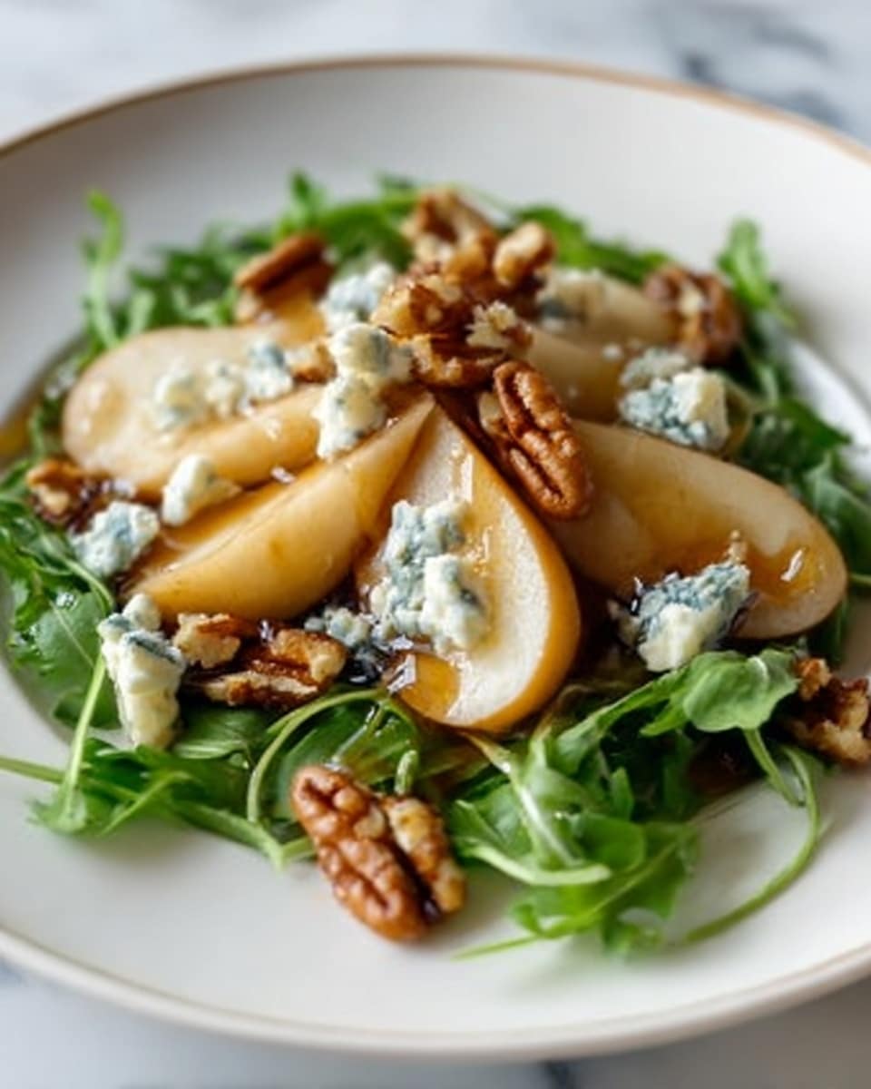 The dish shows a white plate with fresh green arugula leaves as the base layer. On top, there are several slices of light golden-brown pears placed in a small pile towards the center. Scattered over the pears and arugula are small chunks of blue cheese, creamy with blue veins. Toasted brown nuts, likely walnuts or pecans, are spread evenly over the top, adding texture. A light drizzle of honey or syrup glistens on the pears and cheese, adding shine and contrast. The background is a white marbled surface. photo taken with an iphone --ar 4:5 --v 7