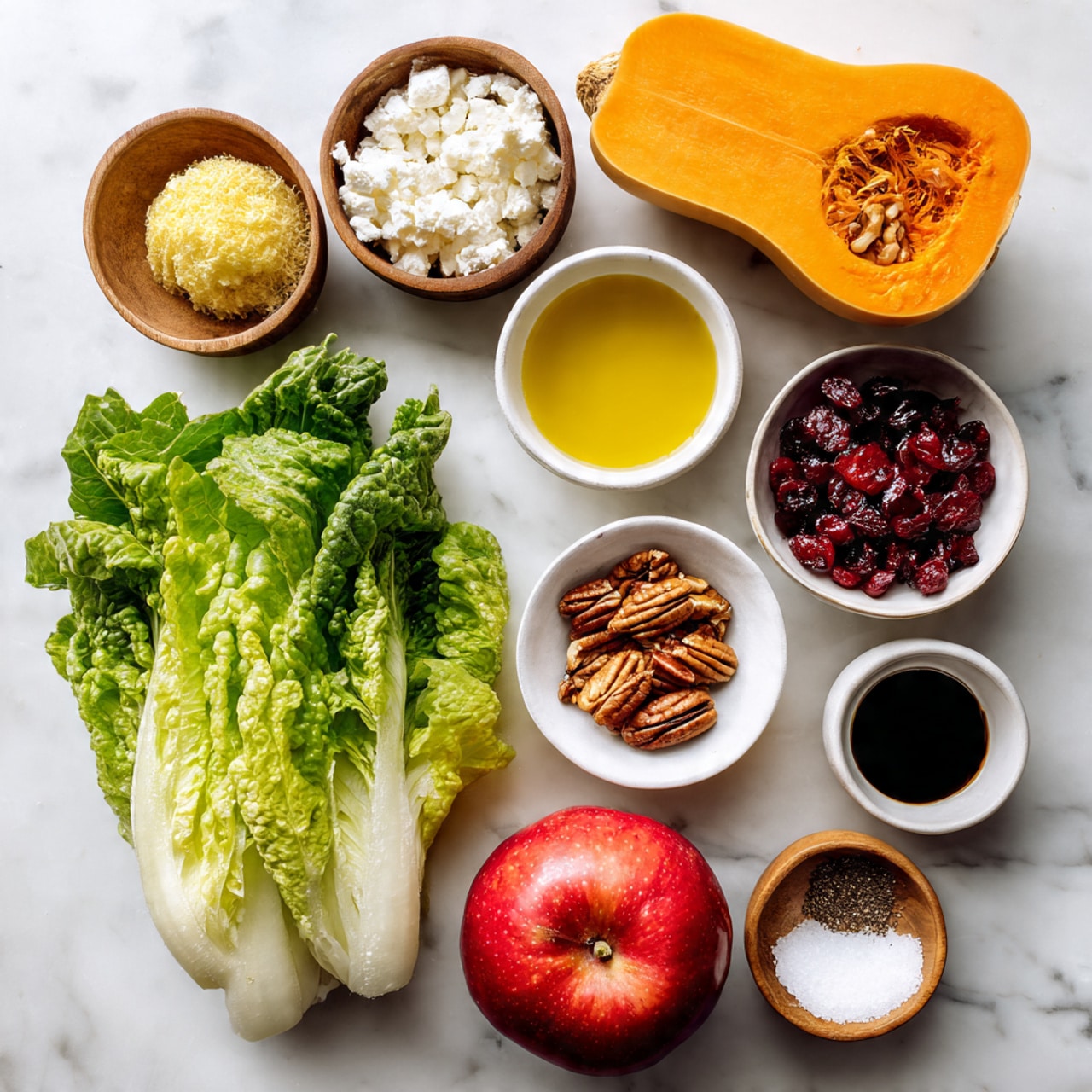 The image shows raw ingredients arranged neatly on a white marbled surface, including a light orange butternut squash on the top right, a bunch of bright green romaine lettuce leaves on the bottom left, and a round, red apple on the bottom right. There are small white bowls holding golden olive oil, crumbled white cheese, dried red cranberries, and brown pecan halves. Near the apple, there is a small bowl with yellow mustard, and two small wooden bowls containing white salt and black pepper. A small white bowl with dark balsamic vinegar is placed just below the butternut squash. Each ingredient is clearly separated and displayed from a top-down view. photo taken with an iphone --ar 4:5 --v 7
