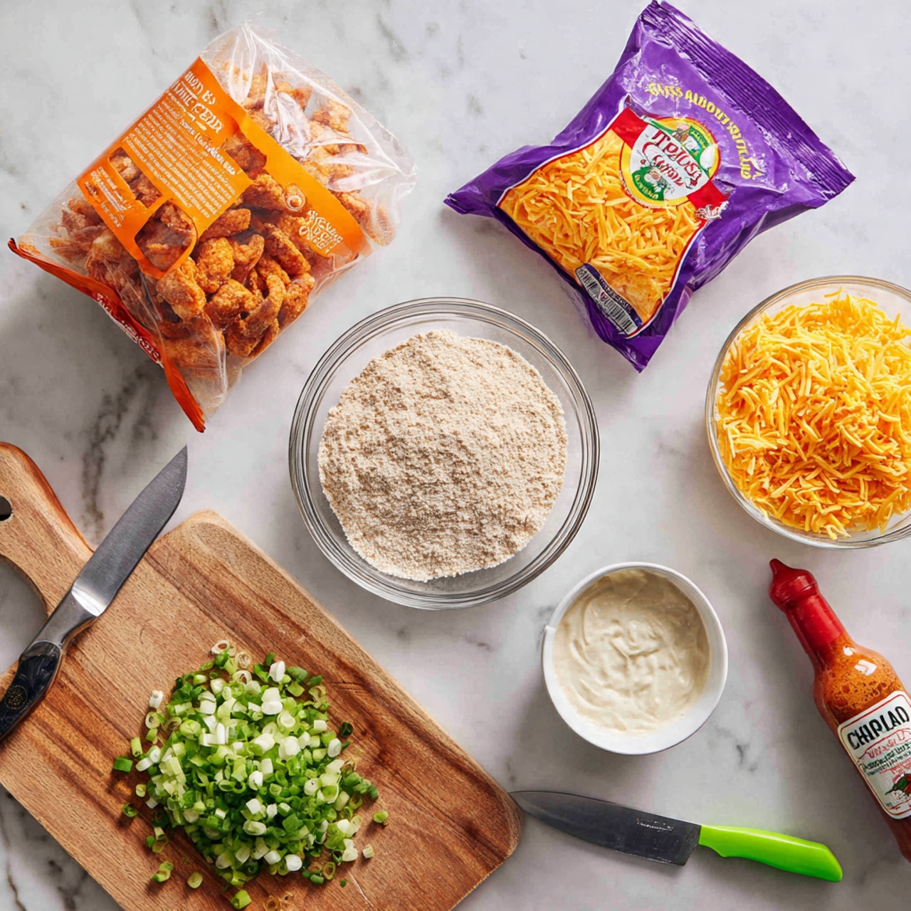 The image shows a white marbled surface with ingredients arranged neatly. From left to right, there is an opened orange bag with crawfish tails, a clear glass bowl with light tan breadcrumbs, a purple packet of shredded cheddar cheese, a white bowl filled with a creamy white sauce, a wooden cutting board with a heap of green chopped scallions, a green-handled yellow knife, a bottle of Tabasco sauce with a red cap, and a clear bottle of Louisiana white pepper sauce. Photo taken with an iphone --ar 4:5 --v 7