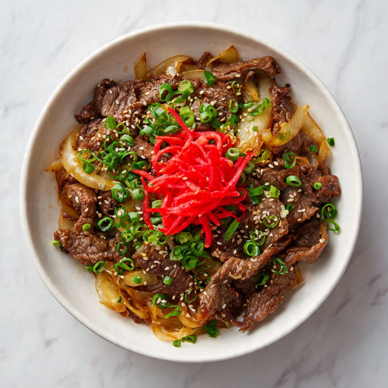 A white bowl filled with a base layer of cooked thin rice, topped with brown cooked sliced beef mixed with translucent cooked onions. On top of the beef and onions is a small pile of bright red pickled ginger strips. The dish is sprinkled with small green chopped scallions and light tan sesame seeds evenly scattered across the surface. The bowl sits on a white marbled texture. Photo taken with an iphone --ar 4:5 --v 7