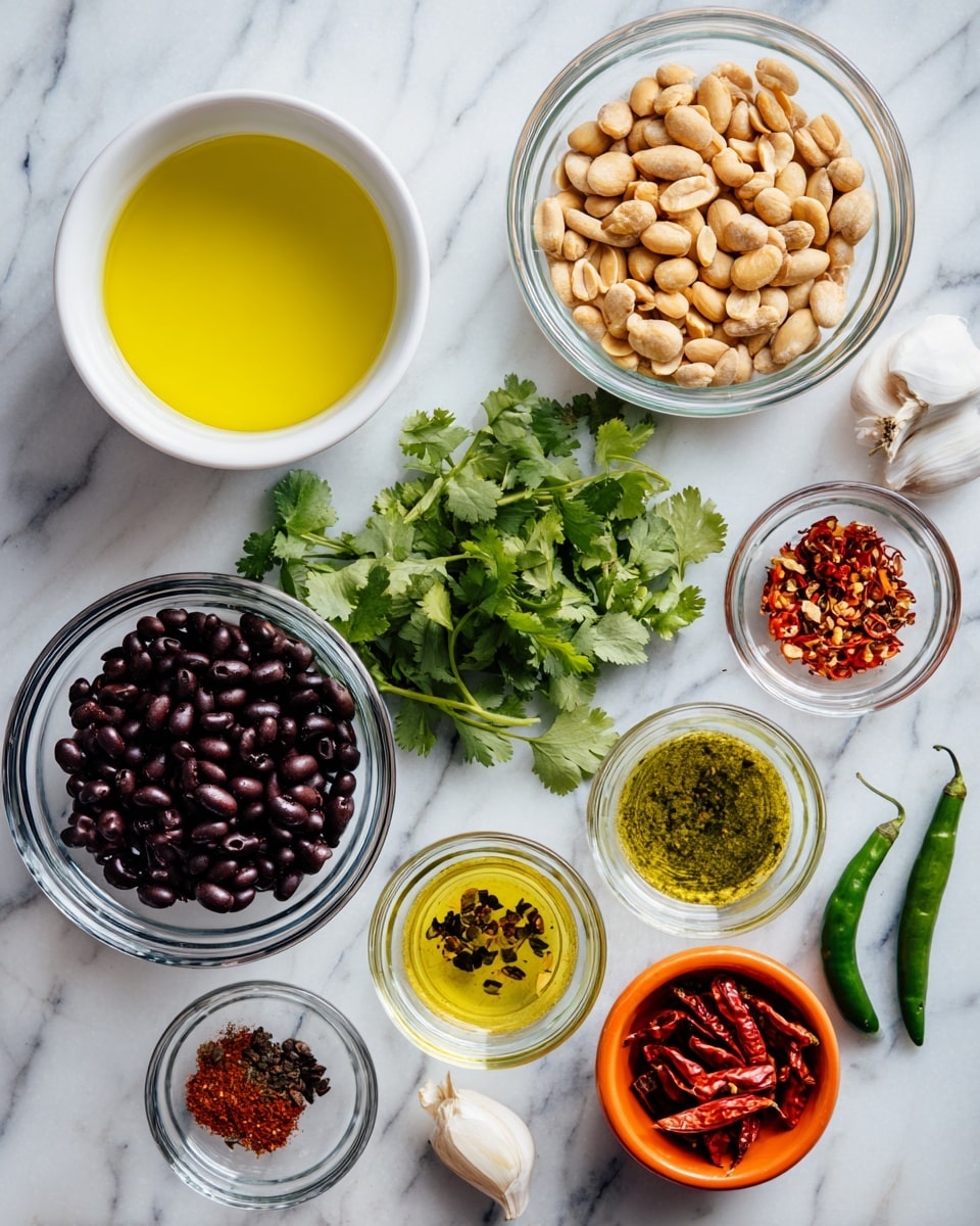 The image shows several clear glass bowls and a white cup with different ingredients on a white marbled surface. Starting from the top left, there is a white cup filled with bright yellow oil. Next to it is a glass bowl filled with light brown peanuts, followed by a bunch of green cilantro leaves. Below the peanuts, a glass bowl holds black beans. To the right, small white bowls contain green oil, bright red dried chili, and a mix of brown and red spices. Near the bottom right, a small bunch of sliced orange dried chilies sits in an orange bowl, next to a single green chili, and two cloves of garlic. The overall layout is neat and organized, showing a variety of colors and textures. photo taken with an iphone --ar 4:5 --v 7