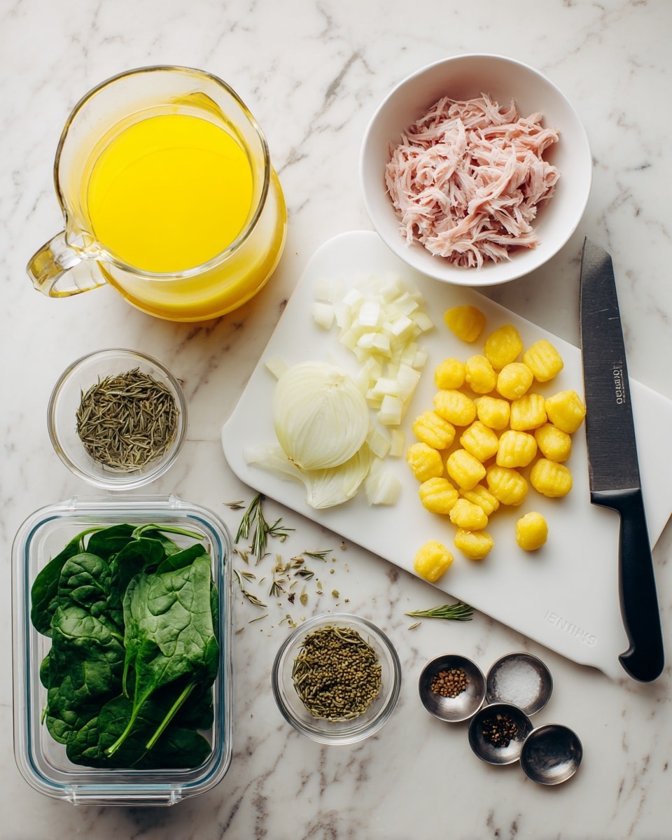 The image shows raw cooking ingredients neatly arranged on a white marbled surface. There is a clear glass pitcher filled with yellow broth or juice in the top left, next to a white bowl filled with shredded pink meat in the top right. Below these are plump, yellow gnocchi in a clear plastic container. To the left bottom corner is a container full of fresh dark green spinach leaves. In the middle of the image is a white cutting board with a large diced onion and some whole garlic cloves, along with a black-handled kitchen knife resting on the board. Around the board, there are scattered onion pieces, garlic cloves, and three silver measuring spoons holding dried seasonings, including fennel seeds and other greenish dried herbs from a tilted spice jar. The colors are fresh and vibrant, and the setup is tidy and ready for cooking. photo taken with an iphone --ar 4:5 --v 7
