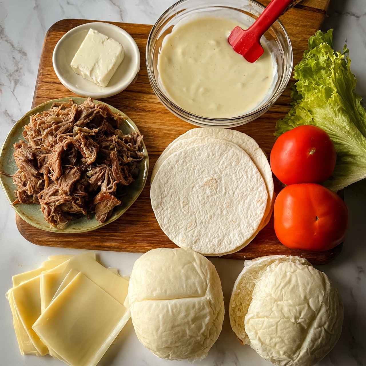 square image The image shows a wooden board on a white marbled surface with various ingredients for a sandwich. There is a pile of shredded meat on a greenish plate on the left side, next to a small round white dish with a block of white cheese. In the middle, a clear glass bowl filled with a light cream sauce has a red spatula inside. Three round white tortillas are placed beside the bowl. On the right side, a whole red tomato and a wedge of green lettuce are present. At the bottom, there are slices of pale yellow cheese on the left and two white sandwich buns, one whole and one split open. Photo taken with an iphone --ar 4:5 --v 7