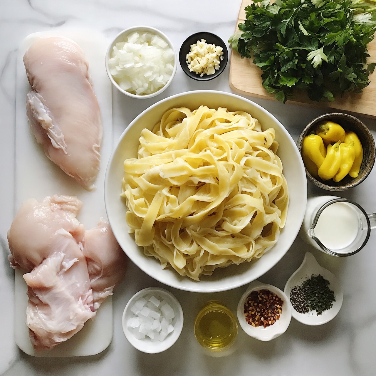 square image The image shows raw ingredients neatly arranged on a white marbled surface for a pasta dish. In the center, there is a white bowl filled with light yellow cooked fettuccine pasta, loosely layered with visible soft texture. To the left, two raw pale pink chicken fillets rest on a white cutting board. Around the pasta bowl, there are small containers holding different ingredients: finely chopped white onions in a white bowl, minced garlic in a small black bowl, yellow banana peppers in a dark ceramic bowl, light golden olive oil in a small glass, and a measuring jug with white cream. Additional small white dishes contain diced white salt, red pepper flakes, black pepper, and dried green herbs. A bunch of fresh green parsley lies on a light wooden cutting board at the top right. All ingredients are spaced evenly, showing their textures and colors clearly. Photo taken with an iphone --ar 4:5 --v 7