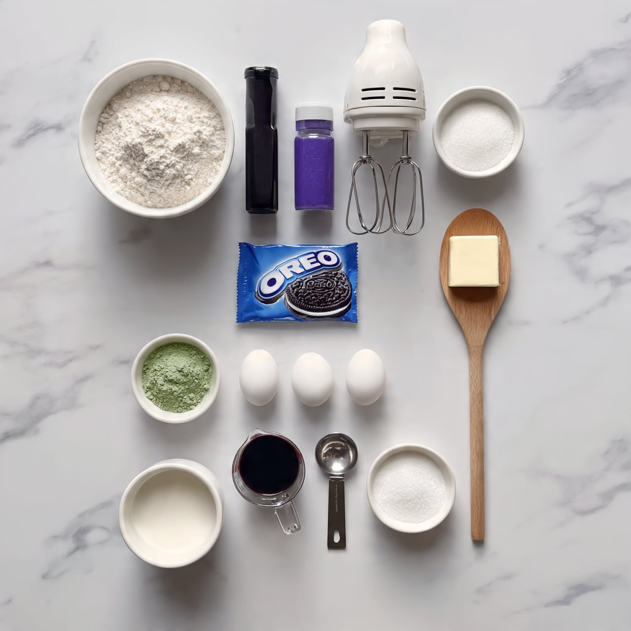 square image The image shows a white marble surface with several baking ingredients neatly arranged. Starting from the top left, there is a white bowl filled with flour. Next to it is a tall dark bottle, a purple spice container, a white electric mixer, and a small bowl of sugar on the right side. Below, closer to the center, lies a blue package of Oreo cookies. On the right side, a wooden spoon holds a square slab of butter. Below, three white eggs sit in a row above a small bowl of green powder, a measuring cup with dark liquid, a metal measuring spoon, and a small bowl of white granulated sugar. At the bottom left, there is a white cup filled with milk. The setup is clean and organized, ready for baking. photo taken with an iphone --ar 4:5 --v 7