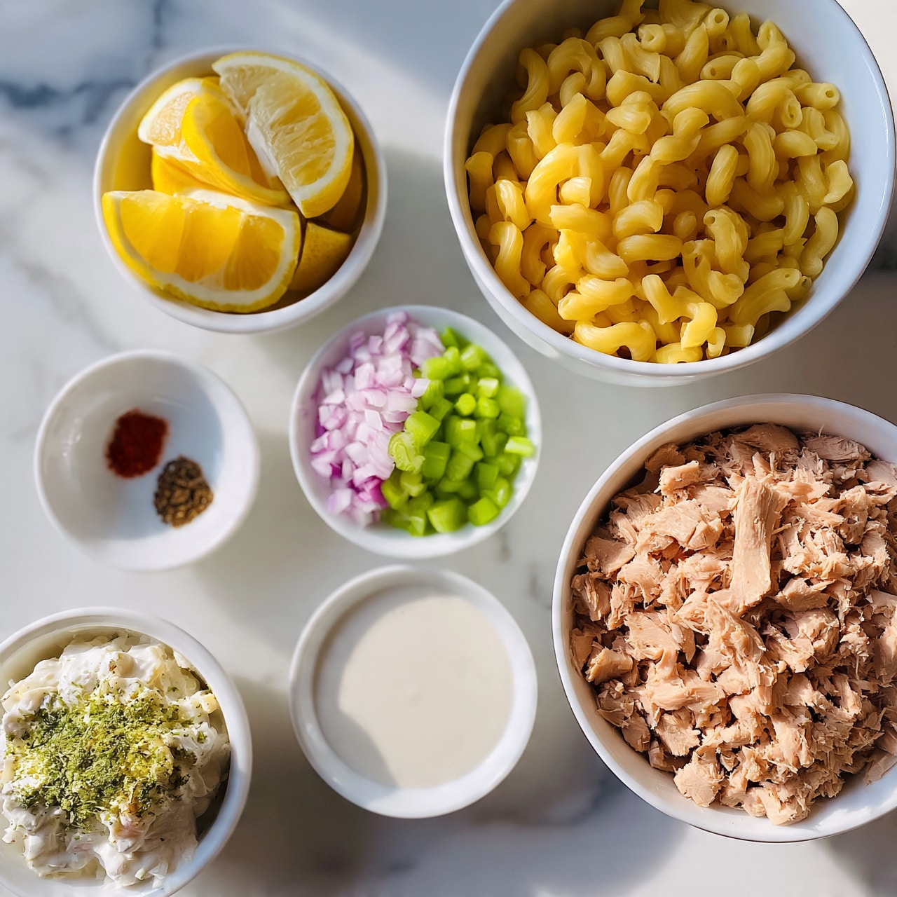 square image The image shows six white bowls placed on a white marbled surface. The largest bowl on the right side holds shredded light brown tuna. Next to it, a bowl of cooked elbow macaroni is golden yellow. A bowl on the top left contains lemon wedges, bright yellow with white rinds. Another small bowl nearby has two small piles of spices, one is red and the other is dark brown. In the bottom left corner, a bowl contains a creamy mixture with green seasonings on top. Two smaller bowls in the middle are filled with finely chopped red onions and bright green celery, separated clearly in one bowl and plain white sauce in the other. photo taken with an iphone --ar 4:5 --v 7