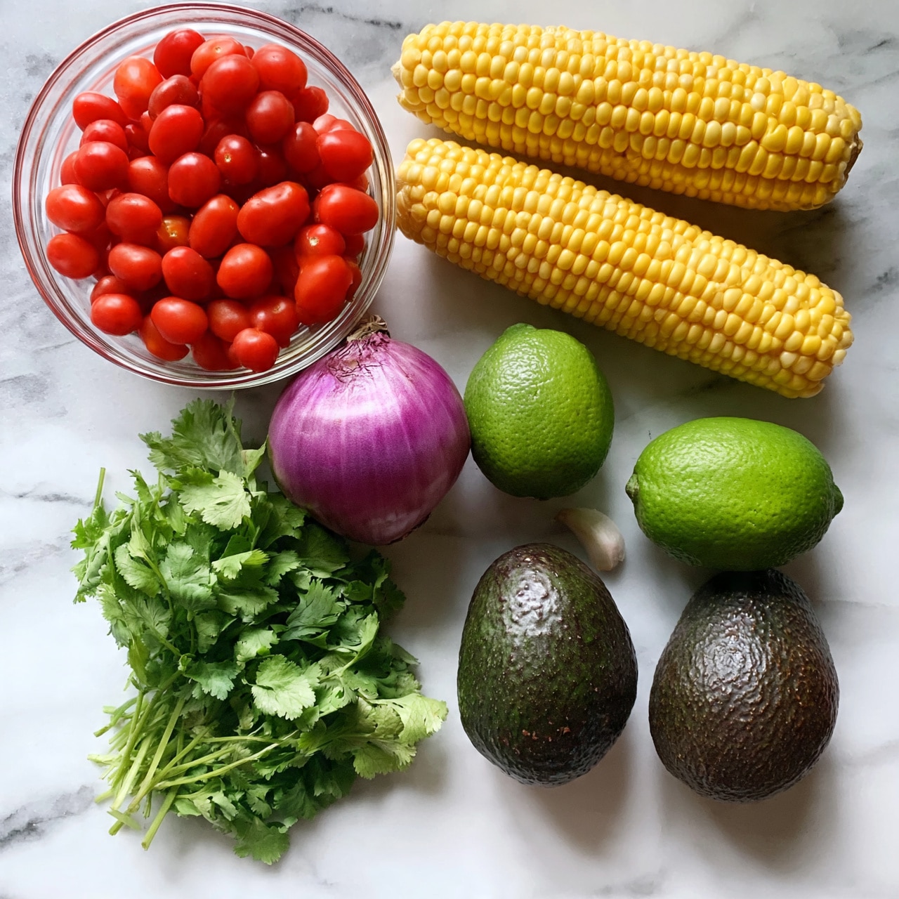 square image The image shows a white marbled surface with fresh ingredients laid out neatly. There are two bright yellow corn cobs on the upper right side. To the left, a clear round bowl filled with small red cherry tomatoes is placed. Below the bowl, there is a small purple onion, two whole limes, two whole dark green avocados, and a small bunch of fresh green cilantro next to some loose cilantro leaves. A single clove of garlic sits near the limes. The colors are vibrant and the textures clear, showing the fresh quality of each ingredient. Photo taken with an iphone --ar 4:5 --v 7