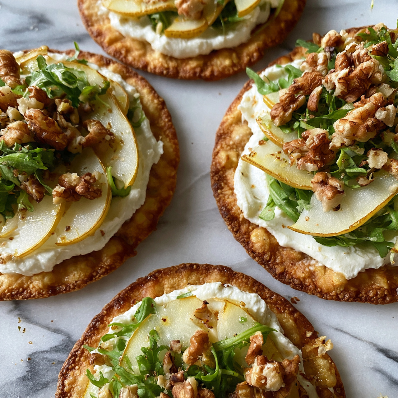 square image The image shows several flatbread pizzas arranged on a white marbled surface. Each flatbread has a golden-brown crispy base topped with thin slices of pale yellow pear, small green leafy arugula, creamy white cheese spread, and scattered brown walnuts for texture. The layers are clearly visible with the pear slices placed on the cheese, arugula lightly covering them, and walnuts sitting on top. The lighting enhances the fresh look and different textures of the toppings. Photo taken with an iphone --ar 4:5 --v 7