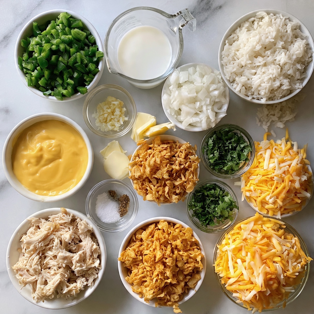 square image The image shows a top view of various ingredients placed on a white marbled surface, arranged neatly in separate bowls and small glass containers. There are twelve items total: chopped green peppers in a white bowl at the top left, minced garlic in a small glass bowl below it, a clear measuring cup with white milk in the center top, chopped white onions in a white bowl to the right, and cooked white rice in a white bowl at the top right. Below these are shredded yellow and orange cheese in a clear bowl at bottom right, chopped cilantro in a small glass bowl next to it, crispy fried onions in a white bowl at center, shredded cooked chicken in a white bowl at bottom left, and smooth yellow cheese sauce in a white bowl in the middle left. Two small glass bowls with white salt and ground spices, and one with two slices of butter sit near the center. The layout is colorful with clear textures visible, all placed on a clean white marbled surface photo taken with an iphone --ar 4:5 --v 7