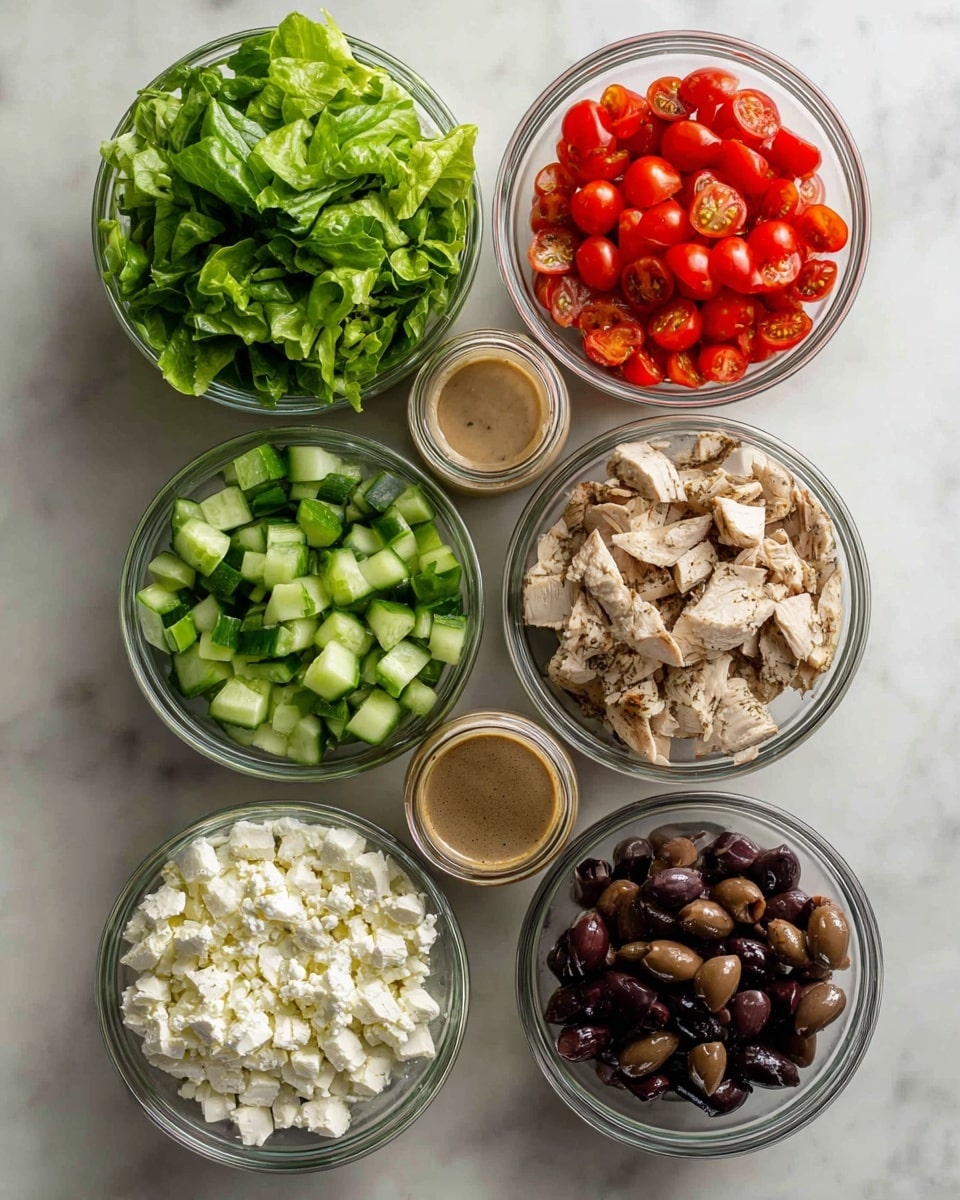 The image shows six clear glass bowls arranged neatly on a white marbled surface. The top left bowl is filled with fresh green leafy lettuce, the top right bowl contains halved bright red cherry tomatoes, and the middle left bowl holds chopped green cucumber pieces with their skin on. Below those, the middle right bowl has sliced pieces of light brown grilled chicken with visible grill marks. The bottom left bowl contains fluffy white cheese, and the bottom right bowl is filled with dark purple sliced olives. In the center of the arrangement, there is a glass jar with a visible light brown dressing. Photo taken with an iphone --ar 4:5 --v 7