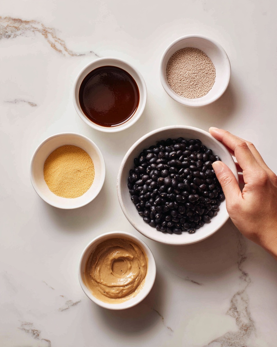 The image shows six white bowls placed on a table with a white marbled surface. In the center, one large bowl holds a pile of dark black beans. Surrounding this, five smaller bowls form a loose circle: one contains a thick, shiny brown sauce; another has a light yellow powder; a third contains a grainy light brown texture; the fourth has a beige paste-like substance; and the last bowl is empty. A woman's hand is reaching toward one of the smaller bowls. photo taken with an iphone --ar 4:5 --v 7