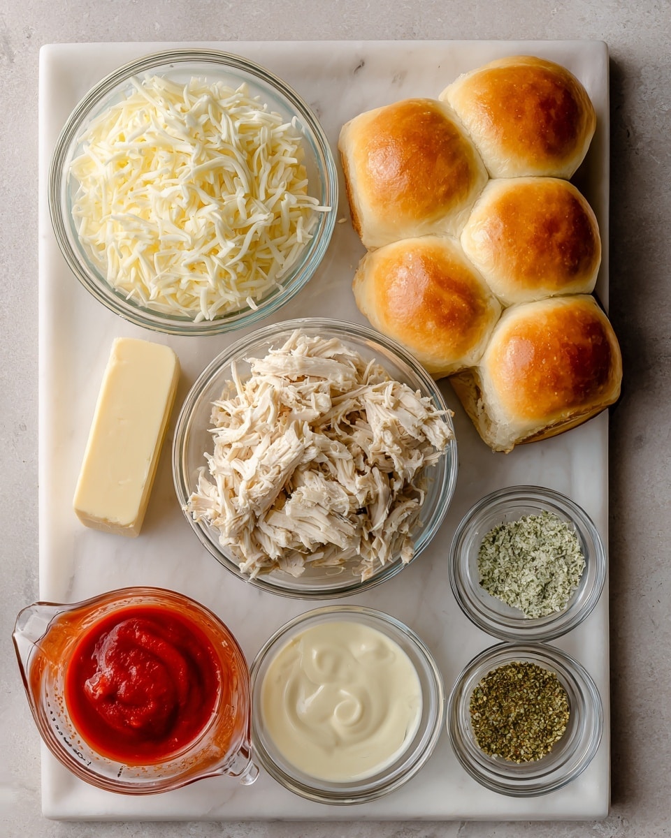 The image shows a white marbled surface with several food items arranged neatly. There is a tray of golden brown dinner rolls in the top right corner, a clear glass bowl filled with creamy shredded chicken placed in the center, and a small clear glass bowl of shredded white cheese above it. To the left of the chicken bowl is a small block of unsalted butter, and below it is a clear measuring cup with bright red tomato sauce. On the right side, three small clear glass bowls hold light brown mustard, green dried herbs, and creamy white garlic sauce. Photo taken with an iphone --ar 4:5 --v 7