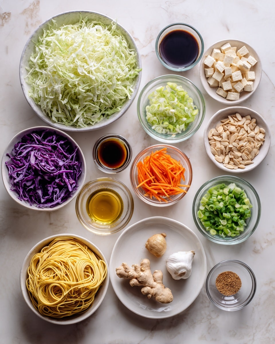 The image shows multiple small white bowls and plates arranged neatly on a white marbled surface. The largest bowl is filled with shredded pale green cabbage, positioned in the top left. Surrounding it are bowls with thin purple cabbage slices, orange carrot ribbons, green chopped scallions, light brown diced tofu, white sesame seeds, and pale green sliced scallions. Smaller glass containers hold light brown slivered almonds, golden oil, clear vinegar, dark soy sauce, and a reddish liquid, along with small piles of salt and pepper. There is a small bowl with three garlic cloves and another with fresh ginger pieces. A white plate holds coiled yellow noodles, and a small bowl contains creamy light brown peanut butter. The arrangement is clean and organized, captured in soft natural light. Photo taken with an iphone --ar 4:5 --v 7