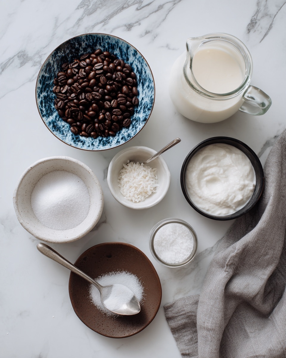 The image shows several small bowls and containers arranged neatly on a white marbled surface. In the bottom center, there is a white bowl filled with white sugar and a spoon. To the left, a white bowl holds dark roasted coffee beans with a cracked blue pattern on the bowl's exterior. Above it, a small white bowl contains white powder, possibly shredded coconut, and next to it another tiny white bowl has white salt. A small glass jar with a white lid is positioned near the top right of the image, containing white liquid, next to a larger glass measuring cup filled with a creamy white mixture. A black bowl with a spoon holds a white powdery ingredient, likely powdered sugar. A brown plate rests empty at the bottom left. A woman's hand in the top right corner holds a gray cloth on the white marbled background. photo taken with an iphone --ar 4:5 --v 7