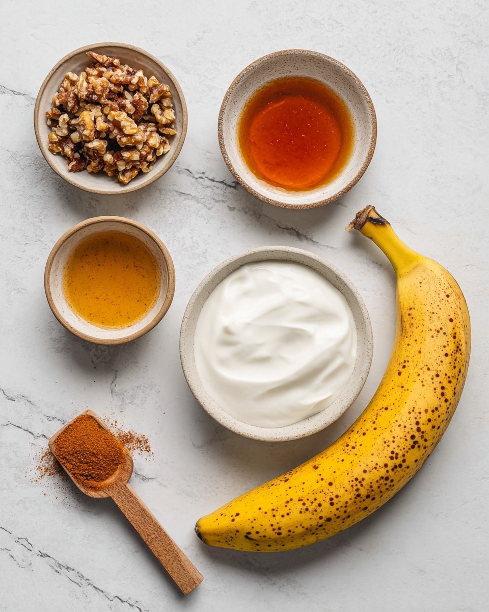The image shows five ingredients arranged on a white marbled surface. From left to right, there is a small bowl containing chopped nuts with a rough texture, a round bowl with amber-colored liquid that looks smooth and shiny, a white bowl in the center holding thick, white creamy yogurt, a small wooden scoop with fine orange-brown powder, and a bright yellow banana with a few dark spots lying on the right side. All items are neatly placed with clear details and natural colors. photo taken with an iphone --ar 4:5 --v 7