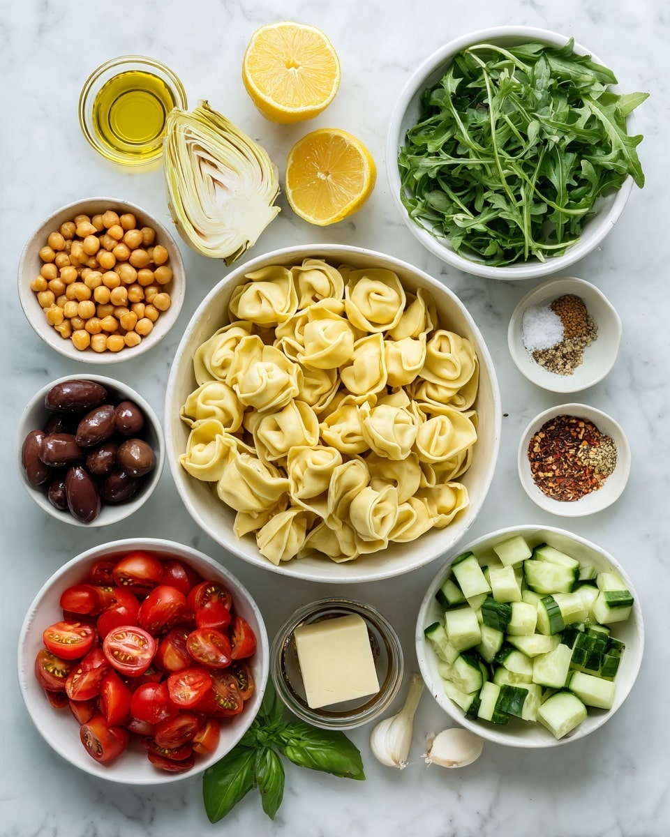 A white bowl filled with light yellow tortellini pasta sits in the center on a white marbled surface. Surrounding it are smaller bowls arranged neatly: to the top right is a white bowl with dark green arugula leaves, below it a white bowl filled with small cucumber cubes in light and dark green shades. On the bottom right is a small bowl with fresh green basil leaves. Directly below the pasta bowl is a bowl of bright red cherry tomatoes, glistening with moisture. To the bottom left is a small bowl with dark brown olives. Above that is a white bowl with orange chickpeas. At the top left, a white bowl holds pale yellow artichoke hearts. Near the center top are two lemon halves, bright yellow and fresh. A small bowl with olive oil, light golden in color, is placed near the top left. A small round bowl with a mix of coarse salt, pepper, and chili flakes is beside the lemon. Another small bowl holds cubed pale yellow cheese. A single garlic clove rests on a small bowl near the left side. A small small jar of balsamic vinegar with dark liquid sits near the center bottom. Everything is on a clean white marbled background. photo taken with an iphone --ar 4:5 --v 7