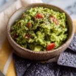 Creamy Homemade Guacamole with Fresh Tomatoes, Lime, and Cilantro Recipe
