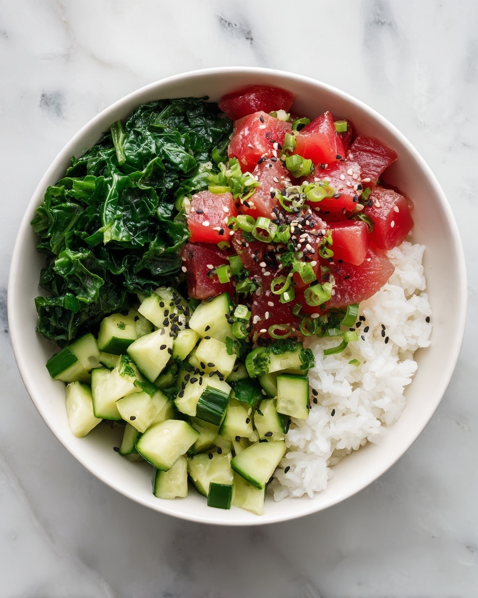 The image shows a white bowl filled with four main layers. At the bottom, there is a layer of white rice. On top of the rice, fresh green leafy spinach or kale is neatly placed on one side of the bowl. Next to the greens, there are diced cucumber pieces scattered evenly. The top layer is bright red chunks of raw fish, likely tuna, mixed with chopped green onions and sprinkled with both black and white sesame seeds. The bowl sits on a white marbled surface, and the overall look is fresh and colorful. Photo taken with an iphone --ar 4:5 --v 7