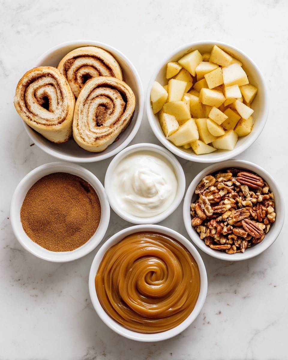 Six small white bowls are arranged over a white marbled surface. At the top left, the first bowl holds light tan cinnamon roll slices with visible spirals of brown cinnamon. Next to it, a small bowl of smooth white cream. The top center bowl is filled with golden yellow apple pieces in a syrupy glaze. To its right, a bowl of chopped pecans in brown shades. Below on the left side, a bowl with brown cinnamon powder. At the bottom center, a small white bowl with a thick swirl of amber caramel sauce. To its right, another bowl with a smooth brown sauce. The simple and clean arrangement highlights the texture and color of all ingredients. Photo taken with an iphone --ar 4:5 --v 7
