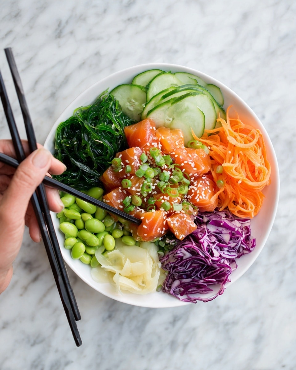 The image shows a white bowl filled with a colorful poke dish, placed on a white marbled surface. Inside the bowl, at the center, are bright orange cubes of raw fish topped with white sesame seeds and chopped green onions. To the left of the fish is a fake woman's hand holding black chopsticks picking up one cube. Around the fish are neatly arranged layers: dark green seaweed salad on the left, light green edamame beans below it, thin slices of pale avocado fan out on the lower left side, light beige pickled ginger is placed beside edamame, thinly sliced cucumber on the upper side, shredded bright purple cabbage above, and thin orange carrot strips arranged on the top right. The whole bowl looks fresh and vibrant. photo taken with an iphone --ar 4:5 --v 7